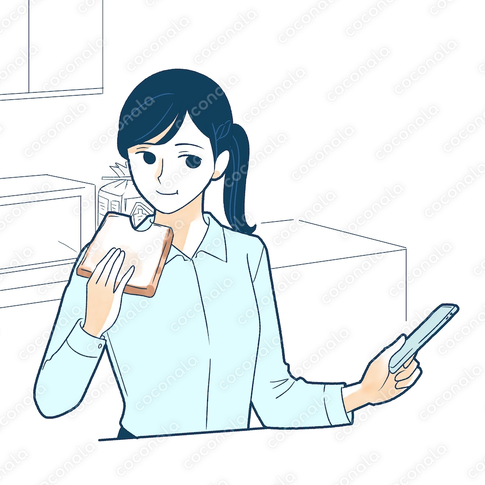 パンを食べながらスマホを確認する女性